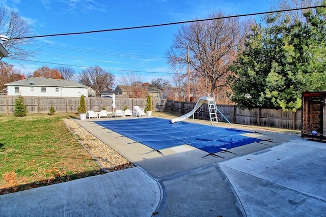 view of swimming pool featuring a patio area and a water slide