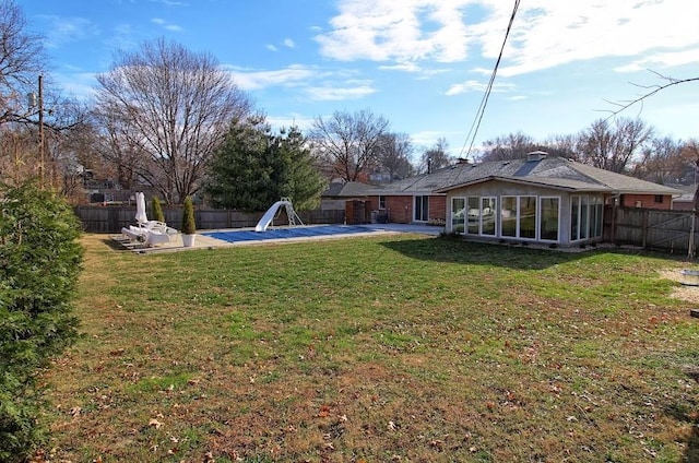 view of yard featuring a patio and a sunroom