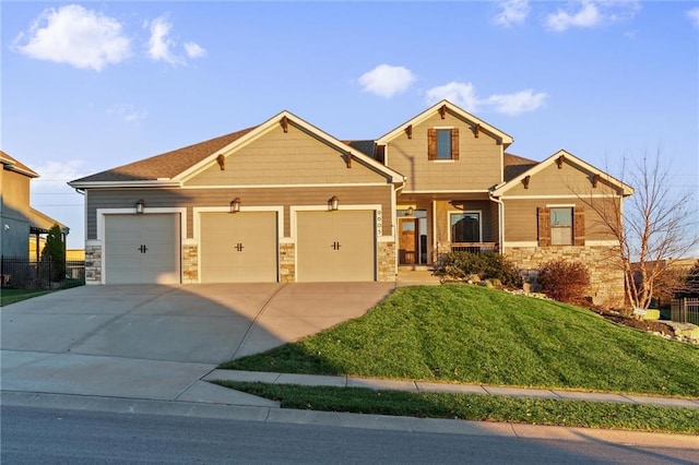 craftsman inspired home with a garage and a front lawn