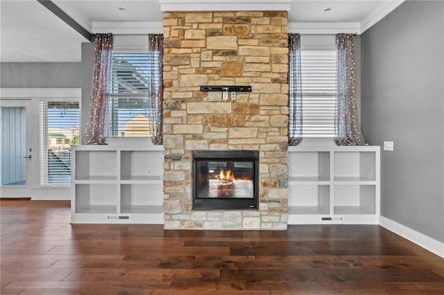 unfurnished living room with a fireplace, dark hardwood / wood-style flooring, and ornamental molding