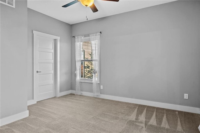 carpeted spare room with ceiling fan