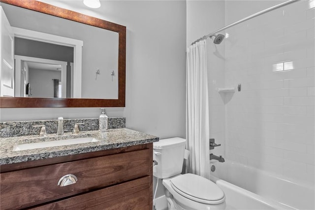 full bathroom with vanity, shower / tub combo, and toilet