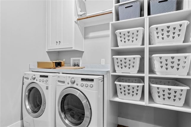 laundry room with cabinets and washing machine and dryer