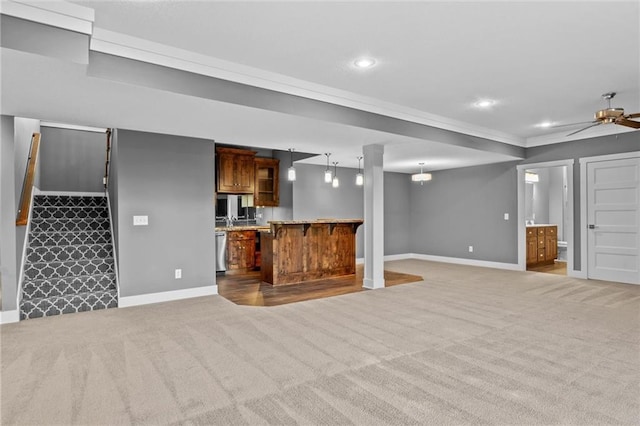 unfurnished living room featuring ceiling fan and light colored carpet