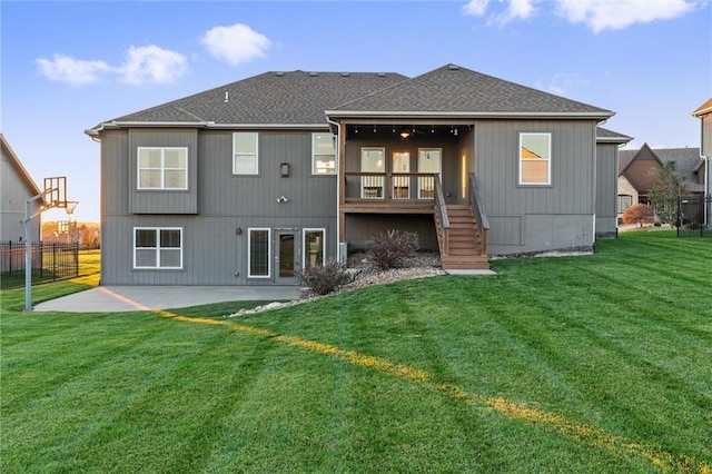 back of house with a patio and a lawn