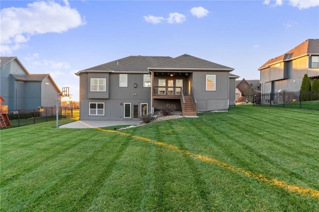 back of property featuring a yard and a patio