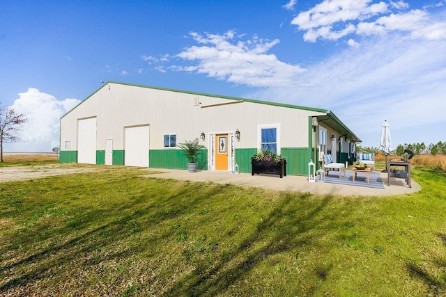 back of property featuring an outbuilding and a lawn