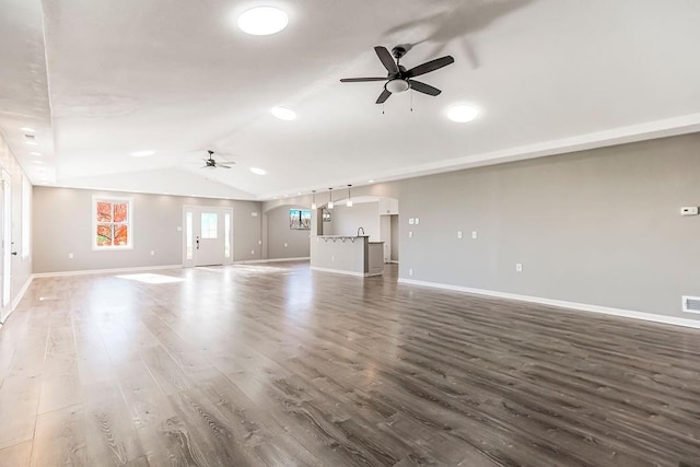 unfurnished living room with lofted ceiling, ceiling fan, baseboards, and wood finished floors