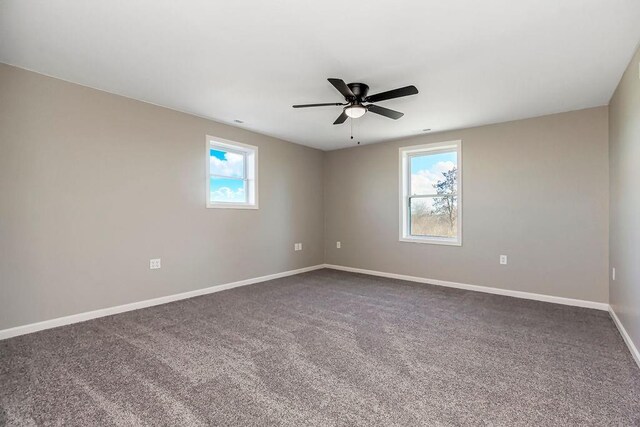 unfurnished room with carpet, plenty of natural light, baseboards, and ceiling fan