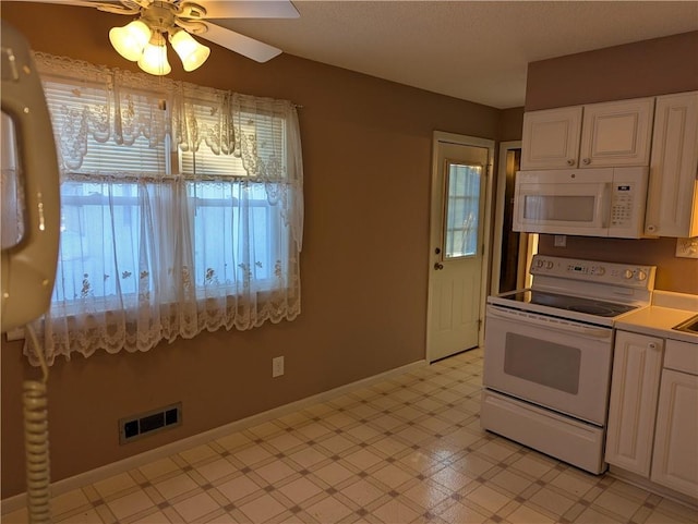 kitchen featuring ceiling fan, white cabinets, and white appliances