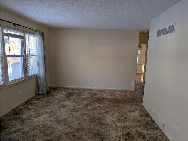 unfurnished room featuring carpet flooring and a textured ceiling