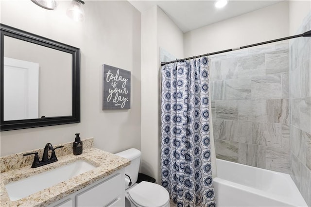 full bathroom featuring vanity, shower / bath combination with curtain, and toilet