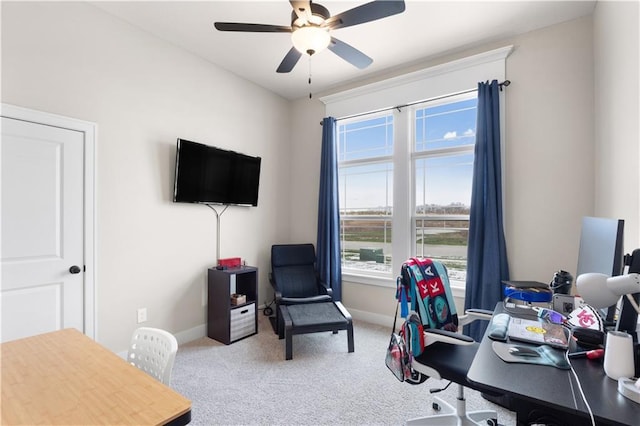 carpeted office featuring ceiling fan