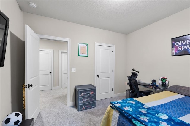 bedroom with carpet and a textured ceiling