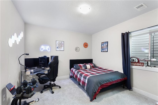 bedroom featuring light carpet and a textured ceiling