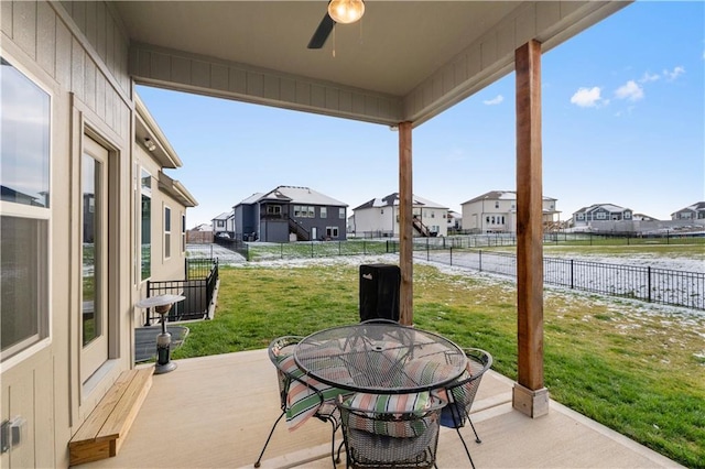 view of patio with ceiling fan and a water view