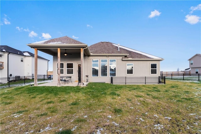 rear view of property with a yard, a patio, and ceiling fan