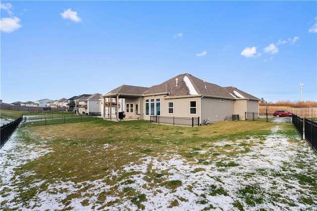 rear view of property with a lawn and central AC unit