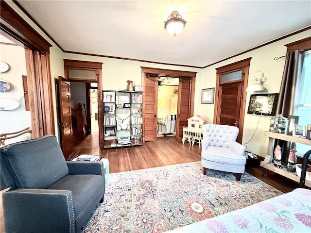 living room featuring hardwood / wood-style floors and ornamental molding