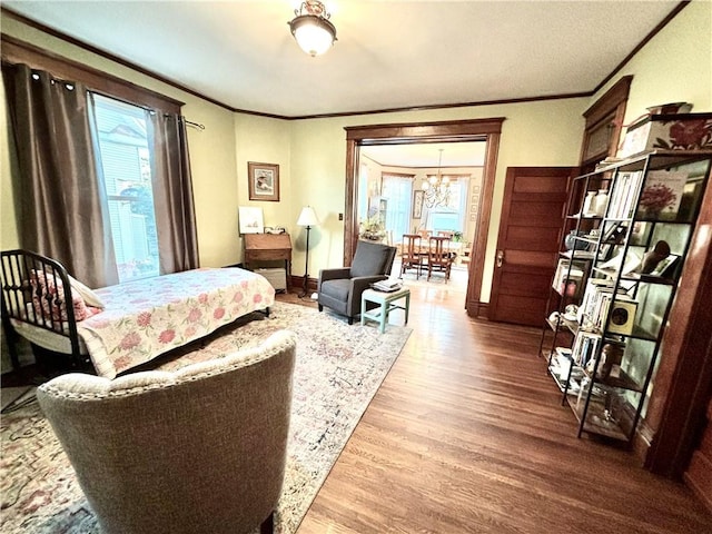 bedroom with hardwood / wood-style flooring, ornamental molding, and multiple windows