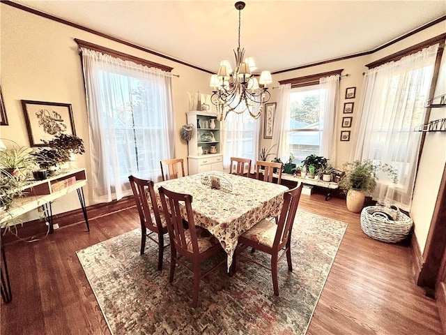 dining room with ornamental molding, dark wood-type flooring, and a chandelier