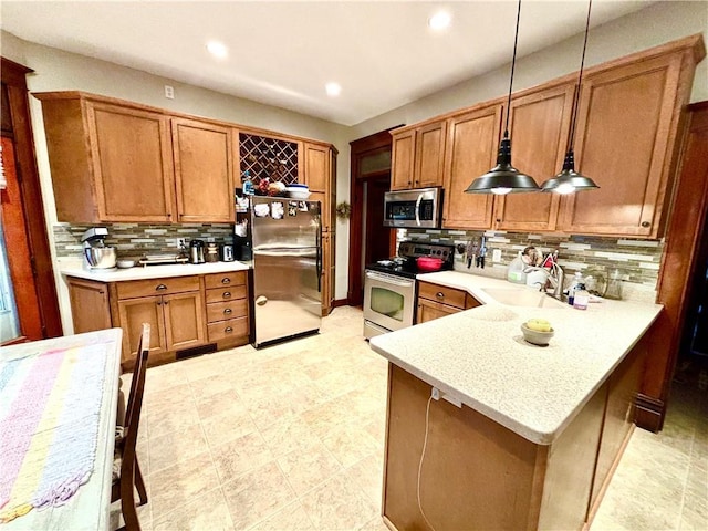 kitchen with sink, decorative light fixtures, decorative backsplash, and appliances with stainless steel finishes