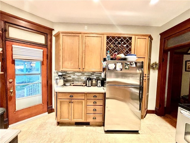 bar with tasteful backsplash and appliances with stainless steel finishes