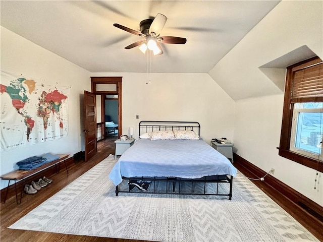 bedroom featuring dark wood-type flooring, ceiling fan, and lofted ceiling