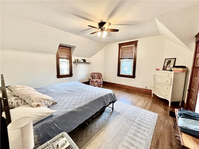 bedroom with lofted ceiling, multiple windows, dark wood-type flooring, and ceiling fan