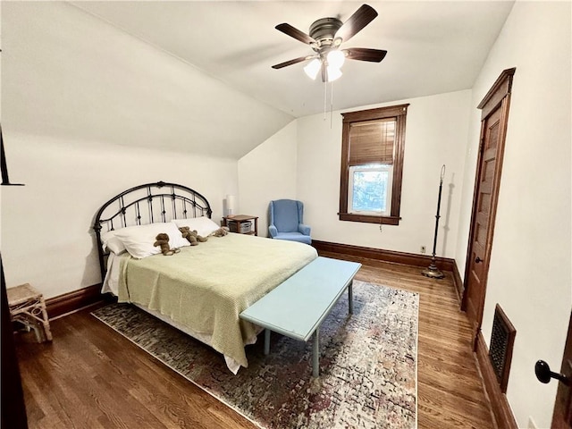 bedroom featuring ceiling fan, lofted ceiling, and dark hardwood / wood-style flooring