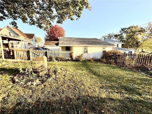 rear view of property featuring a lawn