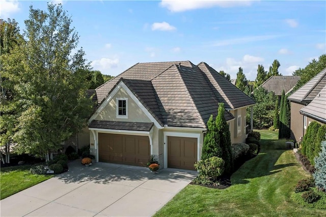 view of front of property with a garage and a front lawn