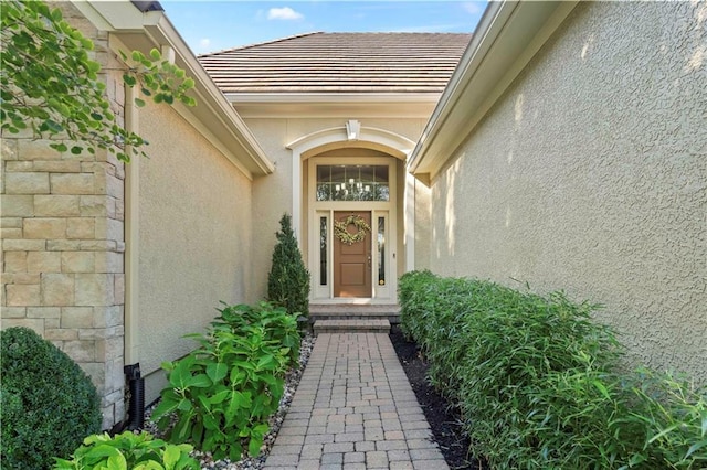 15206 Catalina St, Leawood, KS 66224 - view of exterior entry with stucco siding and a tile roof
