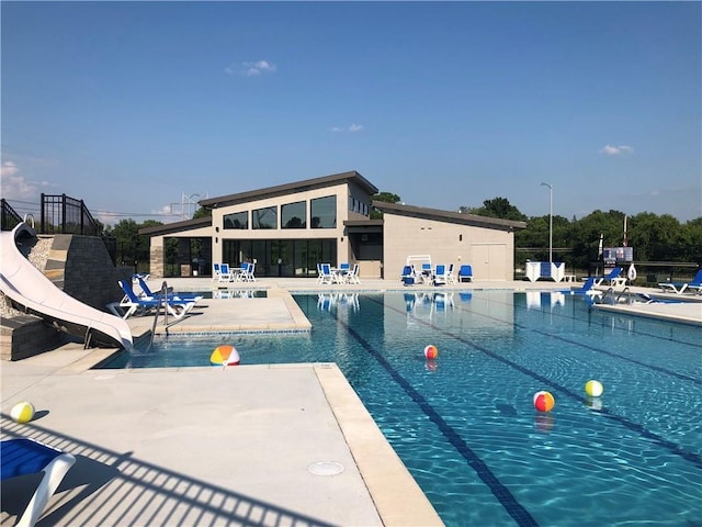 view of pool featuring a patio and a water slide