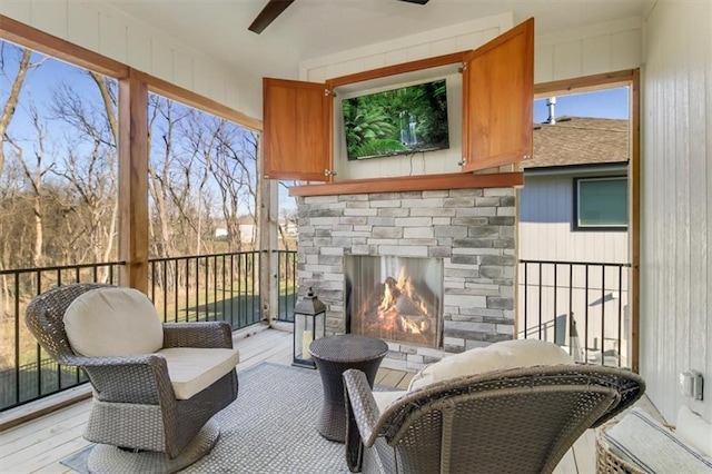 exterior space with ceiling fan and an outdoor stone fireplace