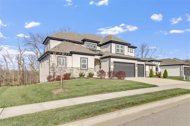 prairie-style house featuring a garage and a front lawn