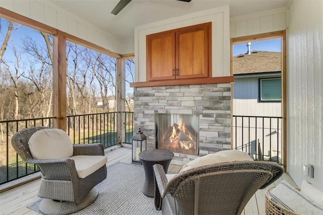 exterior space with ceiling fan and an outdoor stone fireplace