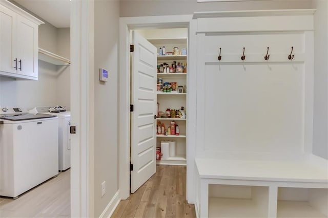 mudroom with washer and dryer and light wood-type flooring