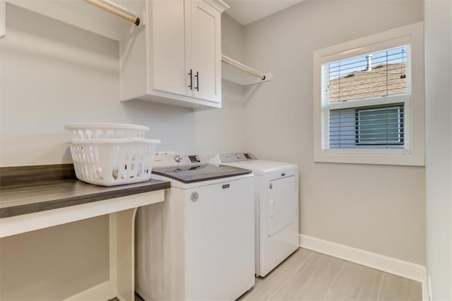 laundry room featuring cabinets and washing machine and dryer