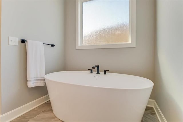 bathroom with a tub to relax in