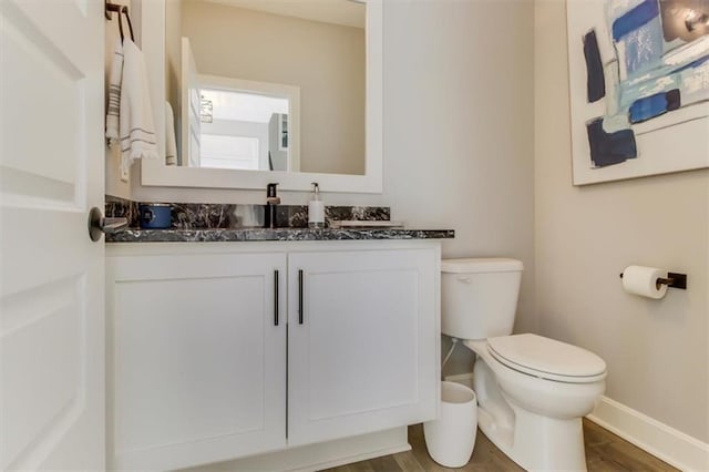 bathroom featuring hardwood / wood-style flooring, vanity, and toilet