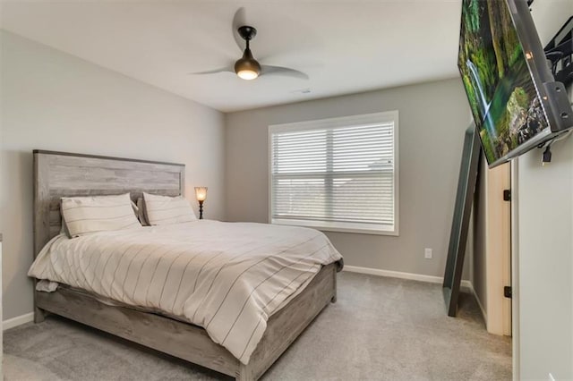 bedroom with ceiling fan and light carpet