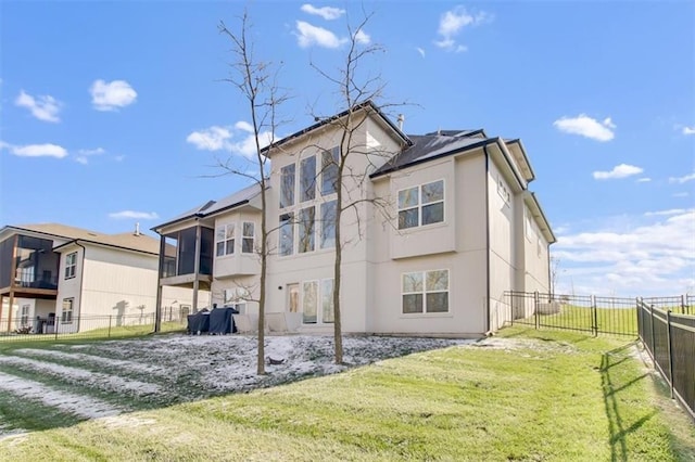 rear view of property featuring a yard