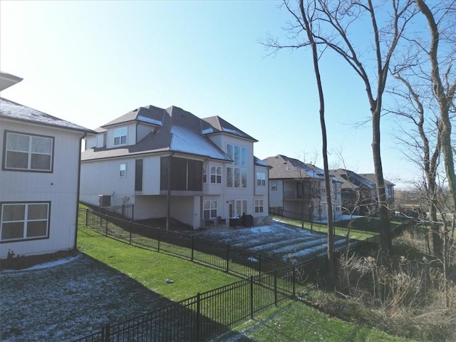 back of house with a lawn