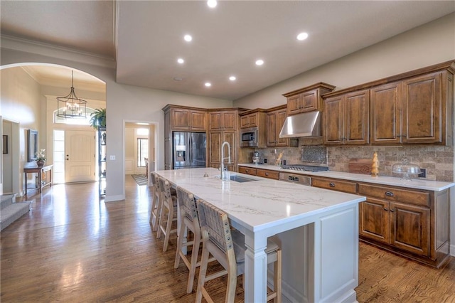 kitchen with a spacious island, a kitchen bar, sink, and appliances with stainless steel finishes