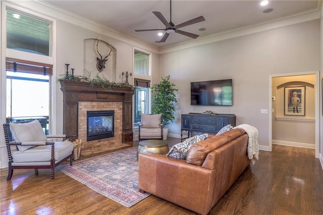 living room with crown molding, ceiling fan, and hardwood / wood-style flooring