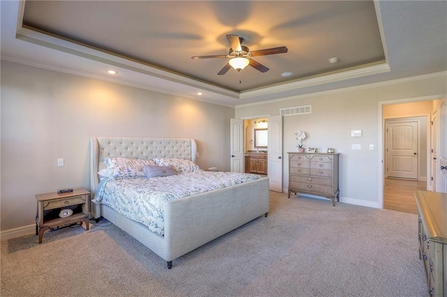 bedroom featuring a raised ceiling, ceiling fan, and ornamental molding