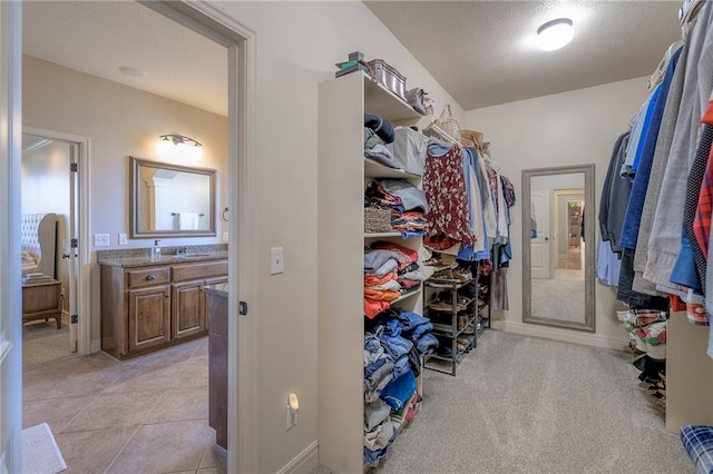 spacious closet featuring light tile patterned floors