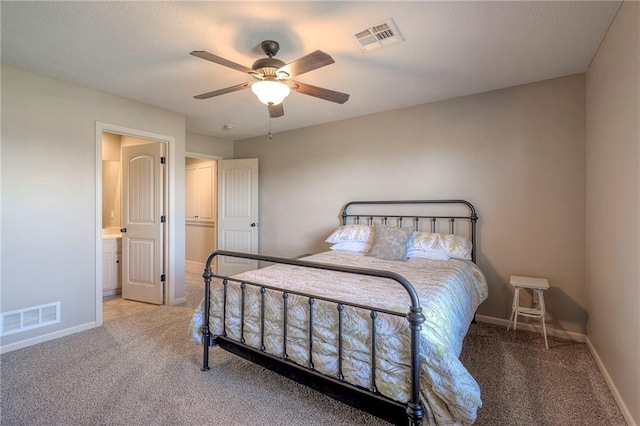 carpeted bedroom with ceiling fan and ensuite bathroom