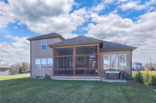 back of property featuring a lawn, a sunroom, and a jacuzzi